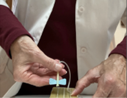 Medical professional drawing blood from a forearm with a syringe and tube in a clinical setting.
