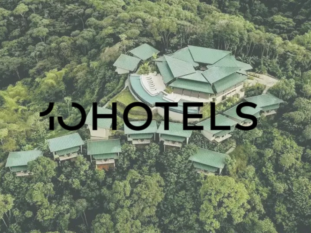 An aerial view of a hotel in the middle of a forest