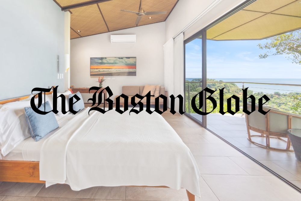 A bedroom with a bed and the boston globe written on it