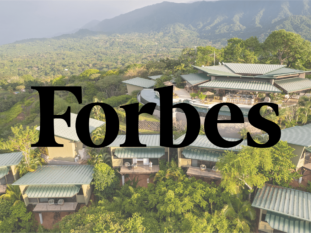 An aerial view of a forbes resort with mountains in the background