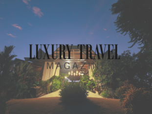 A luxury travel magazine ad with a house in the background
