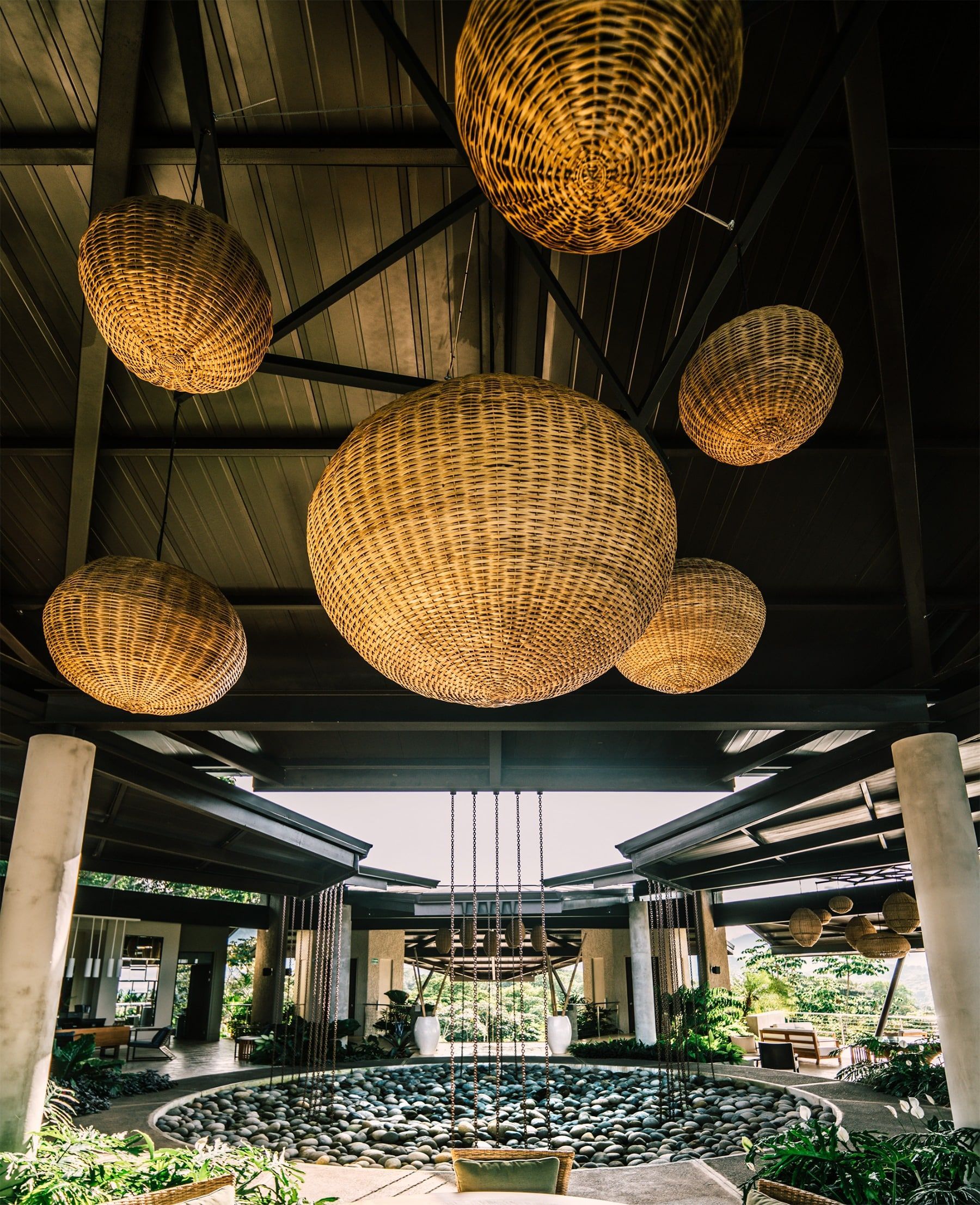 Wicker baskets are hanging from the ceiling of a building