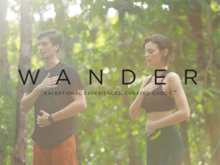 A man and a woman are standing next to each other in the woods.