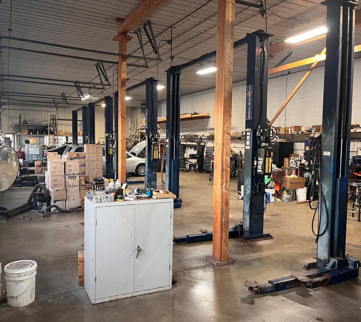 Inside Of Garage With Lifts And Cabinet — O'Fallon, MO — O'Fallon Garage Inside Of Garage With Lifts And Cabinet — O'Fallon, MO — O'Fallon Garage