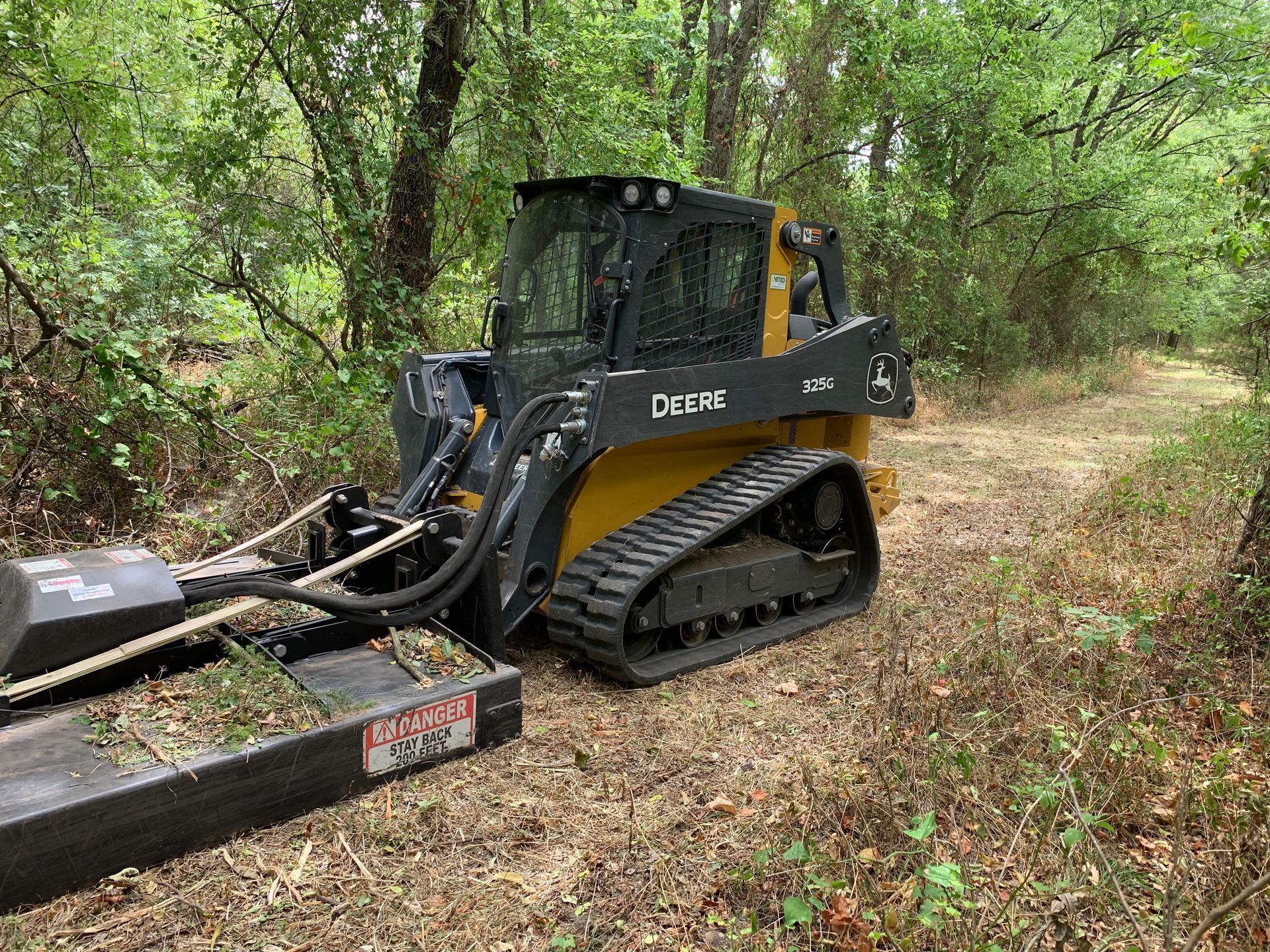 Brush cutting, skid steer trail clearing.