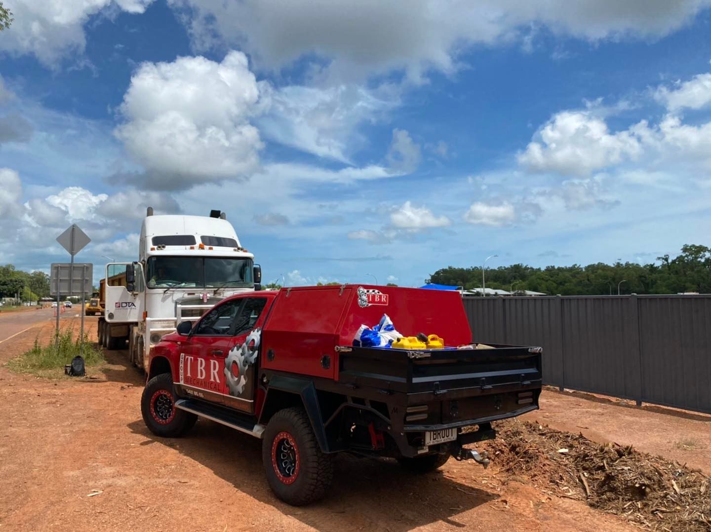 A Man Is Pouring Oil Into A Car Engine — TBR Mechanical in East Arm, NT