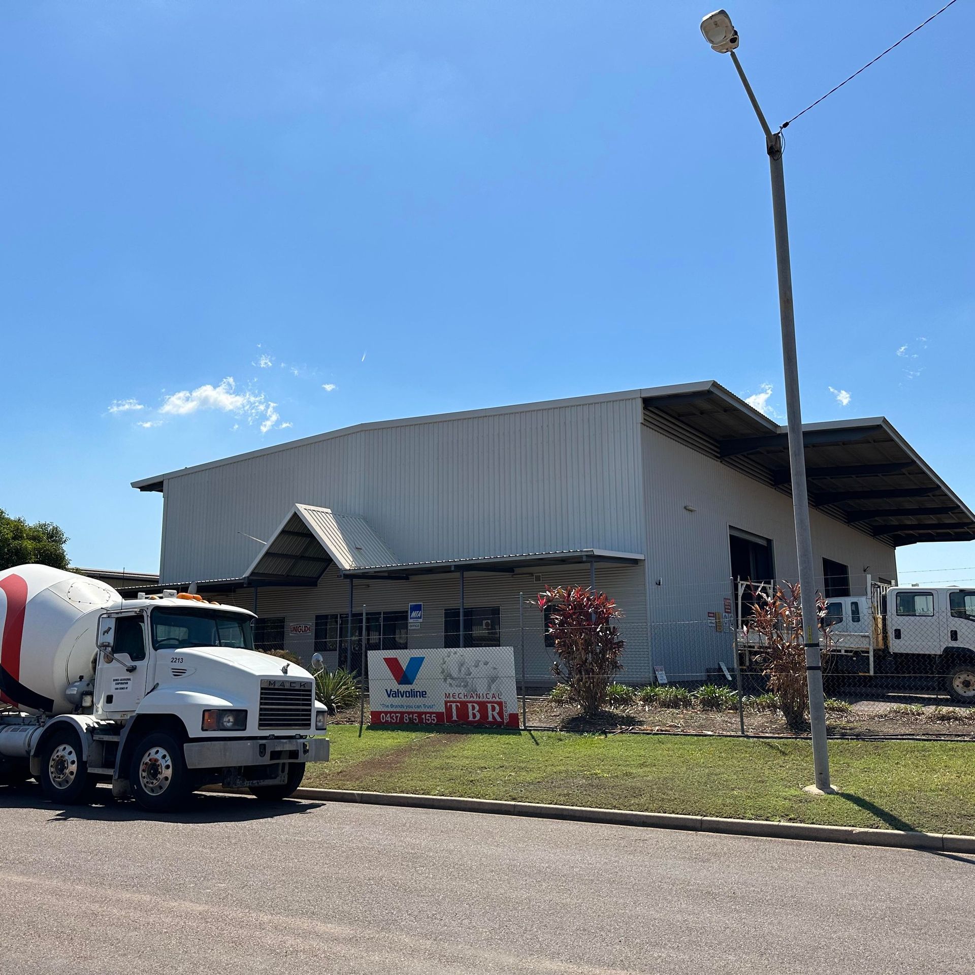 A Man Is Laying On His Stomach Under A Car In A Garage — TBR Mechanical in Katherine, NT