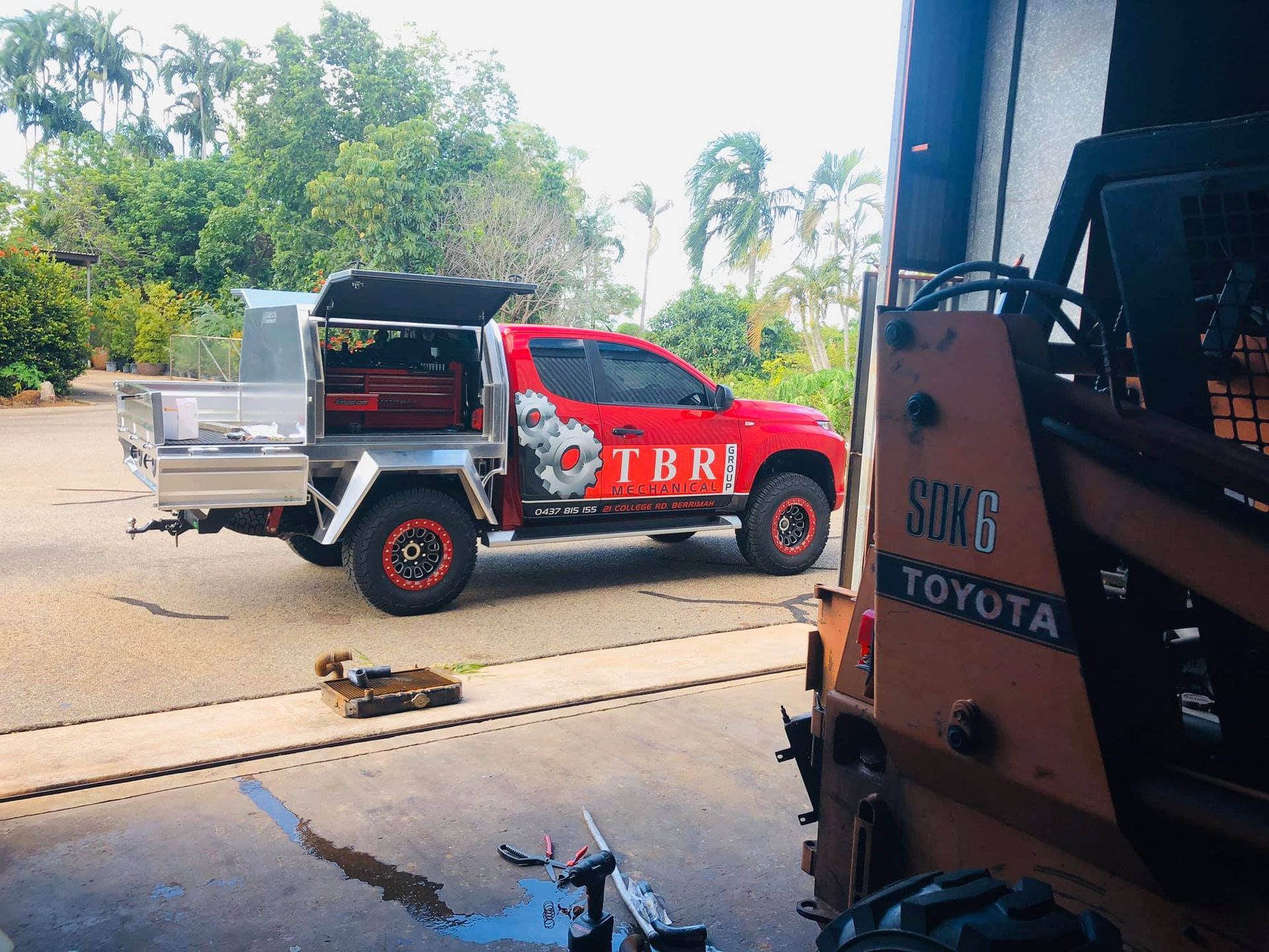 A Man Is Working On The Engine Of A Truck — TBR Mechanical in East Arm, NT