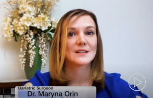 Dr. Maryna Orin, a bariatric surgeon, speaks in front of a vase of flowers.