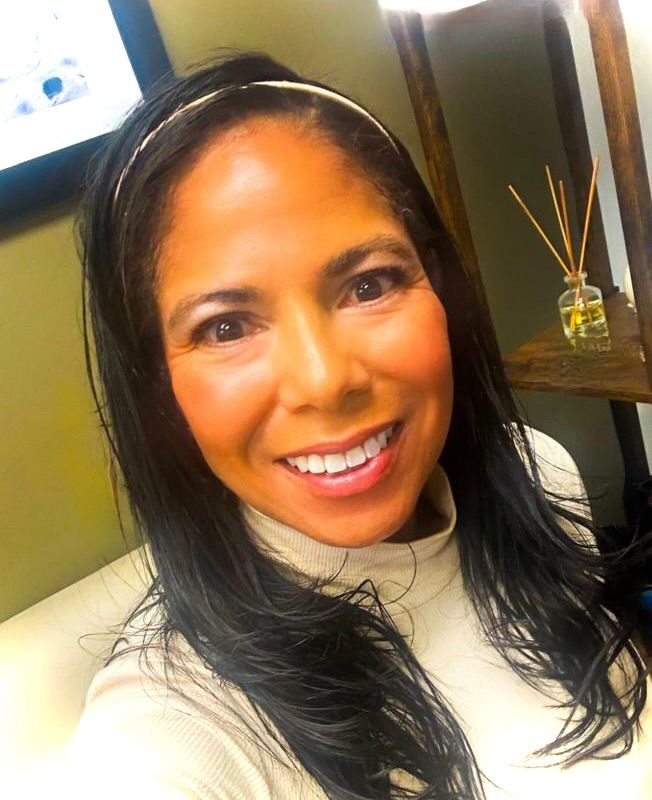 Woman with long black hair and a white shirt