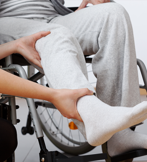 A person in a wheelchair is being helped by another person