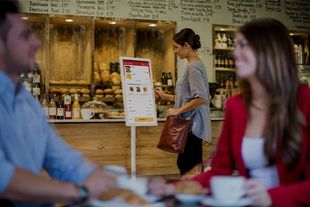 A man and a woman are sitting at a table in a Front client's restaurant.