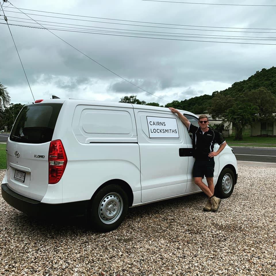 Man in Black Shirt and Shorts Leans on a White Van — Cairns Locksmiths in Freshwater, QLD