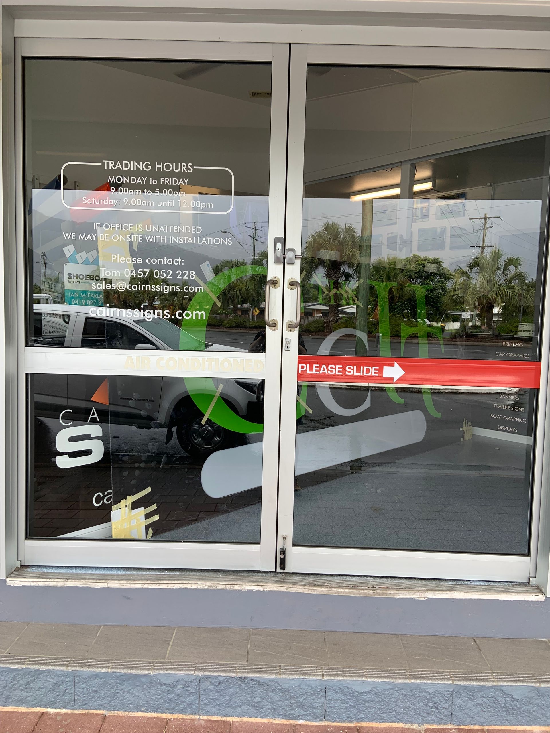 Glass Doors of a Gym With White Trim and a Red — Cairns Locksmiths in Freshwater, QLD