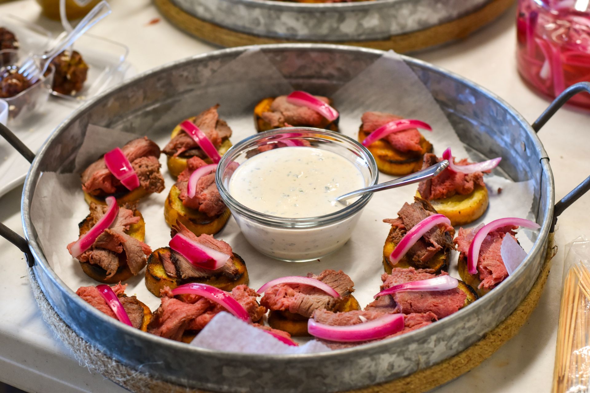 Bruschetta with Steak & Pickled Red Onions in a serving dish