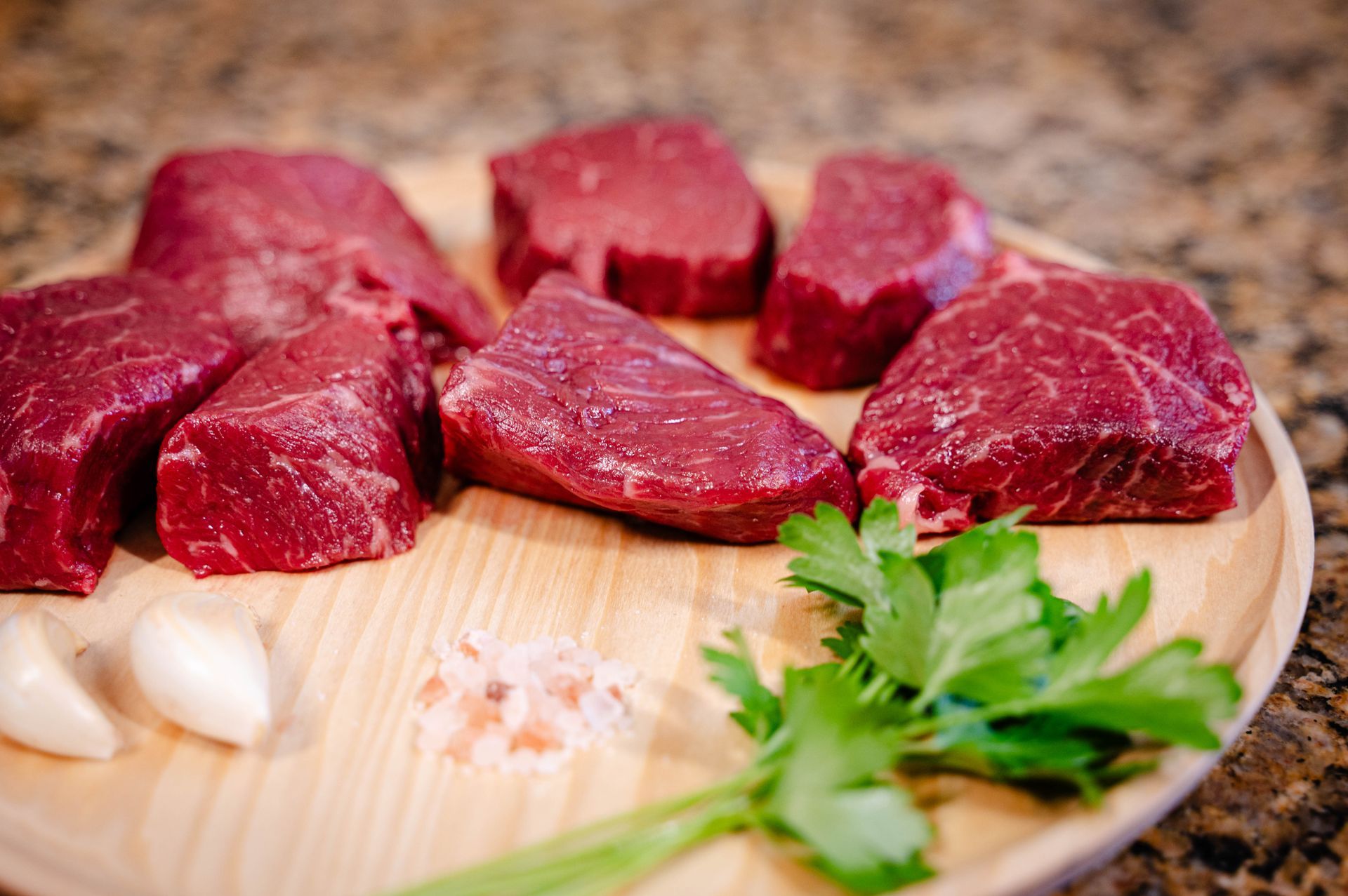 American Waygu kabobs on a wooden bowl