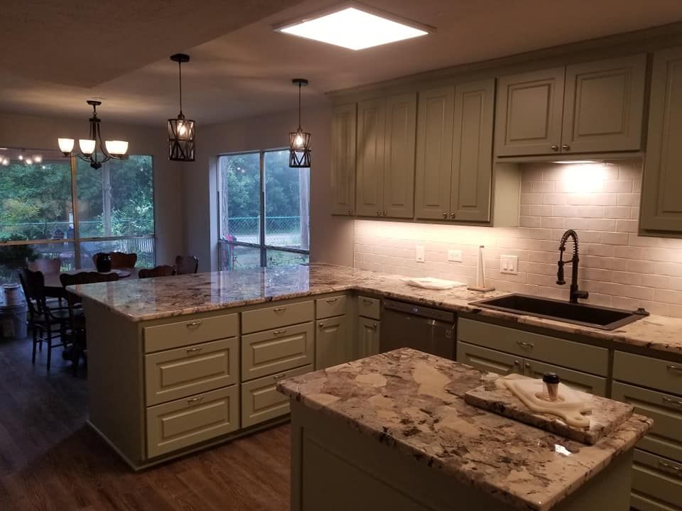 A line icon of a kitchen with a refrigerator , stove , and cabinets.