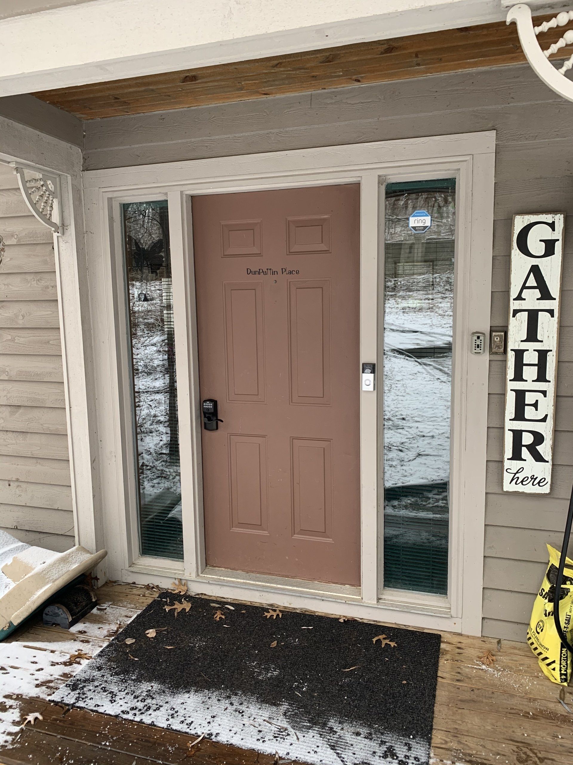 Exterior doorway with a pink door, glass side panels, and a 
