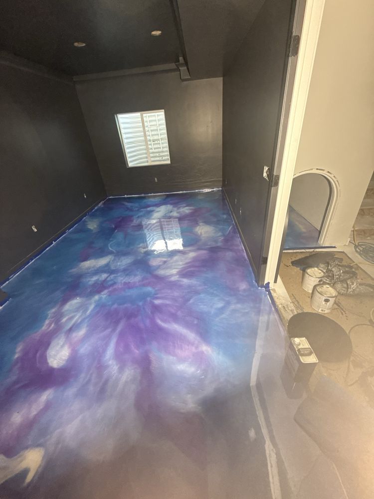 Empty dark room with a blue-purple swirling floor and a bright window at the far end
