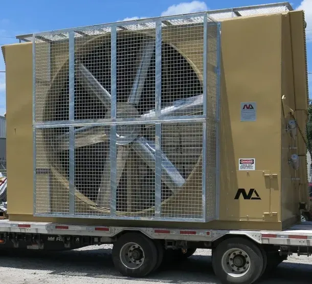 Large industrial fan unit mounted on a flatbed trailer, covered with a metal safety grille