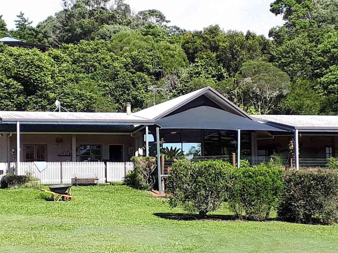 A Large House With a Large Lawn in Front of It Surrounded by Trees — Style Shades Installation In Ravenshoe, QLD