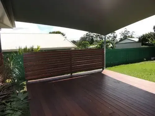 A Wooden Deck With A Fence And A Canopy Over It — Style Shades Installation In Edmonton, QLD