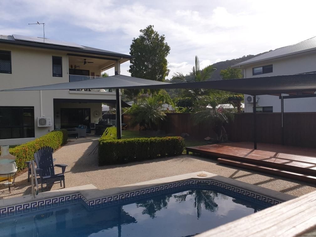 There is a Large Swimming Pool in the Backyard of a House — Style Shades Installation In Dimbulah, QLD