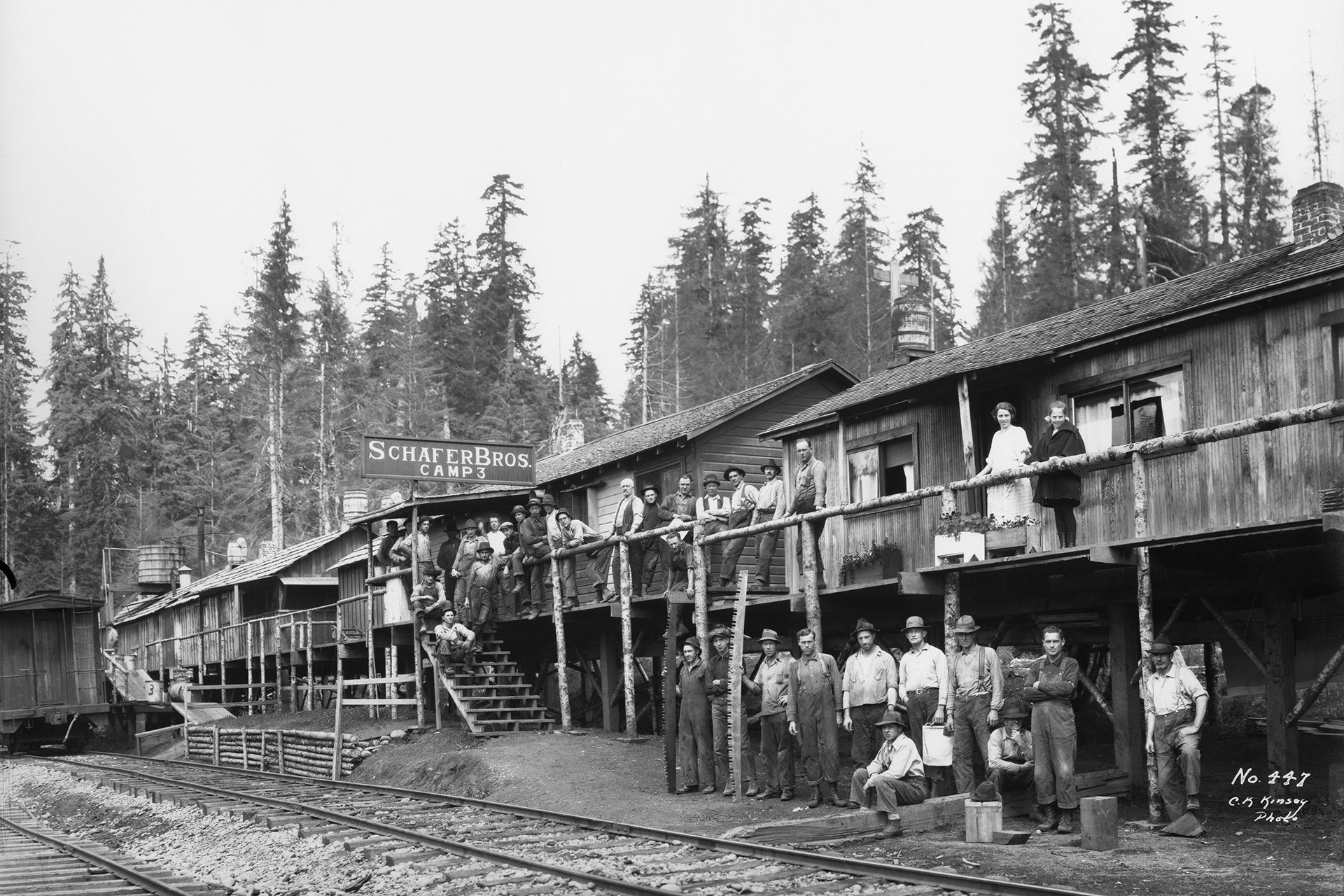 A group of people standing in front of a boat