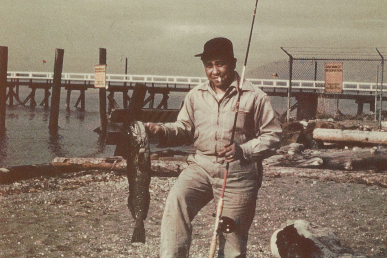 A man with a fishing rod holding a fish