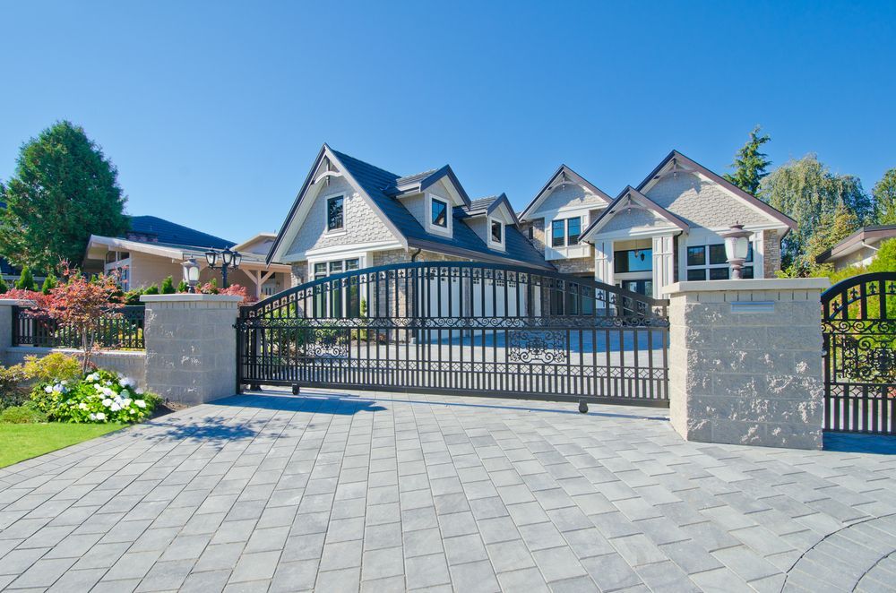 Large House With Grey Brick Driveway — Peterson Property Valuations Brisbane in Northern Growth Corridor, QLD