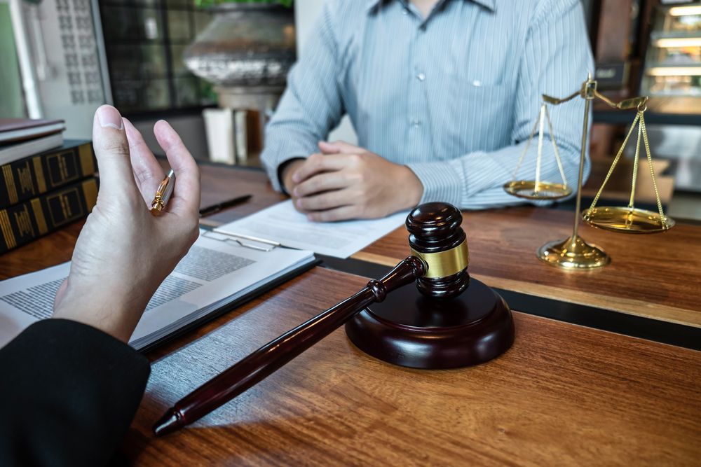 Lawyer Explaining Document to Client — Peterson Property Valuations Brisbane in Caloundra West, QLD