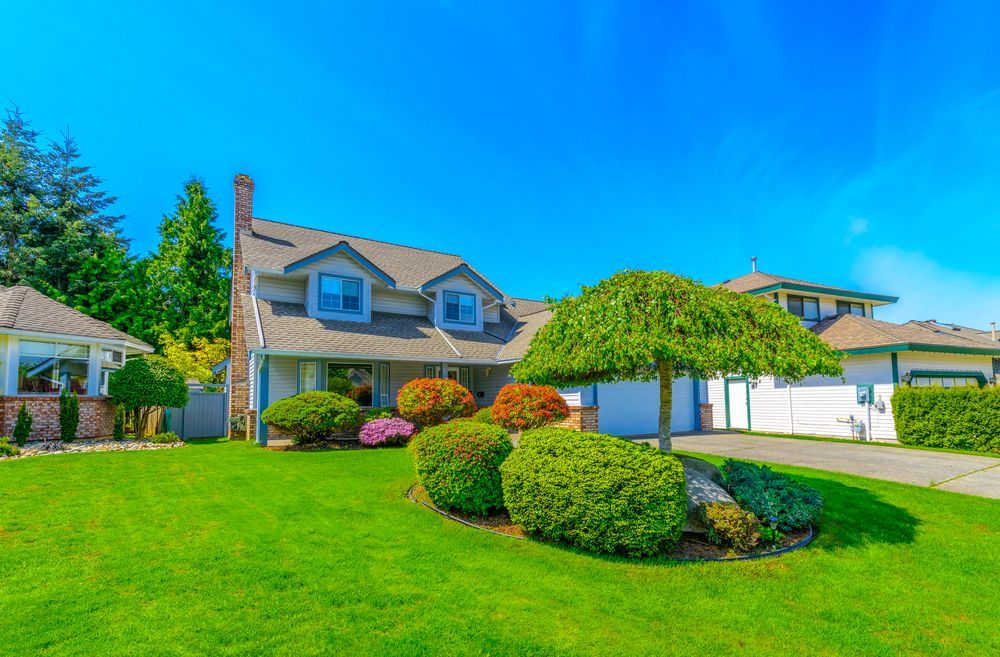Two-Story House With Green Lawn — Peterson Property Valuations Brisbane in Gold Coast, QLD