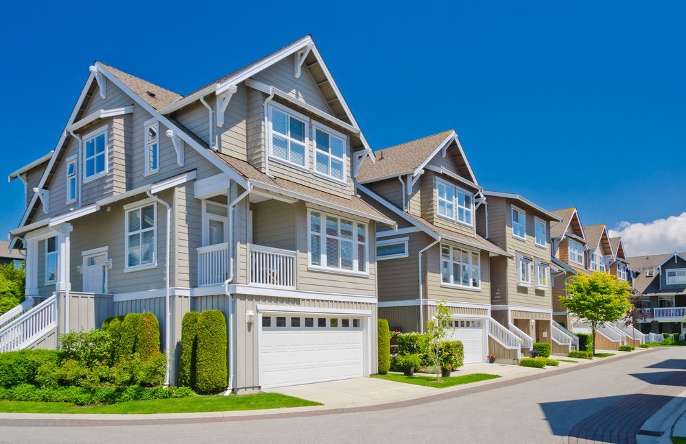 Row of Modern Gray Townhouses — Peterson Property Valuations Brisbane in Burleigh, QLD