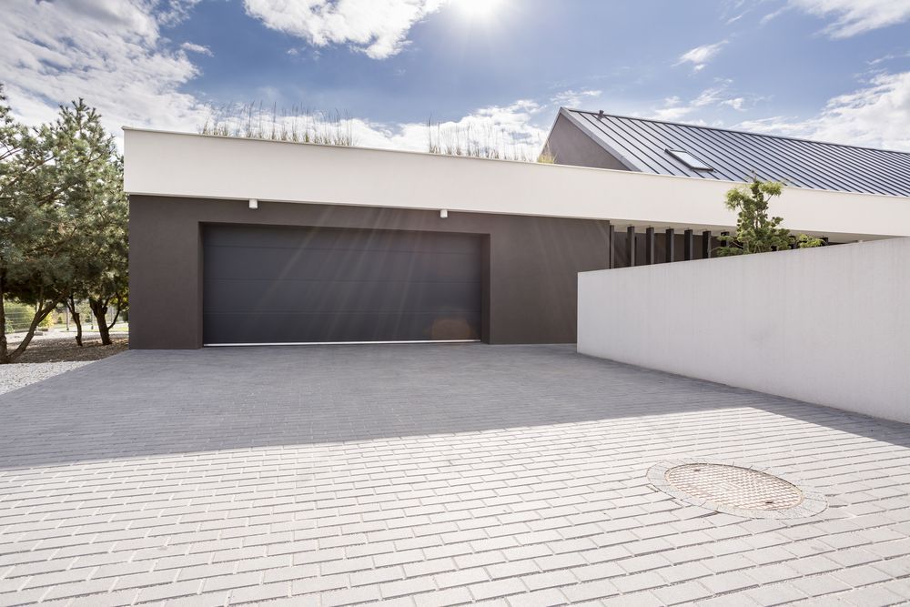 Modern Home With Gray Garage Door — Peterson Property Valuations Brisbane in Caboolture, QLD