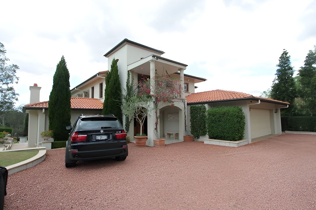 Large Beige House With a Red-tiled Roof — Peterson Property Valuations Brisbane in Caloundra West, QLD