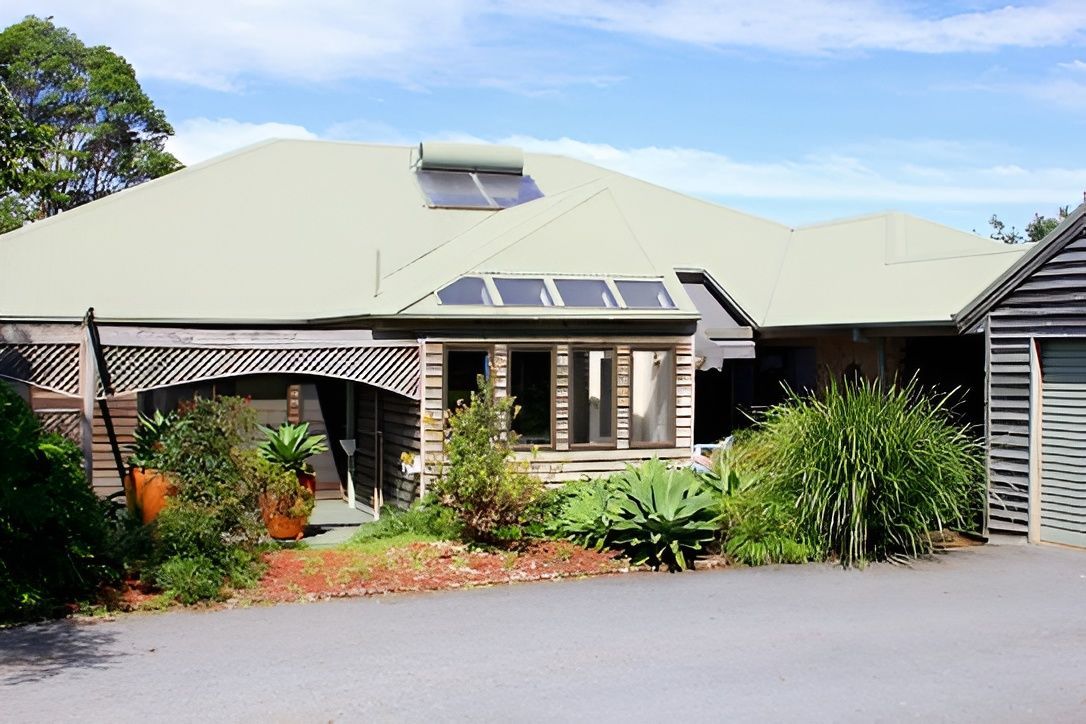 House With Light Green Roof — Peterson Property Valuations Brisbane in Caloundra West, QLD