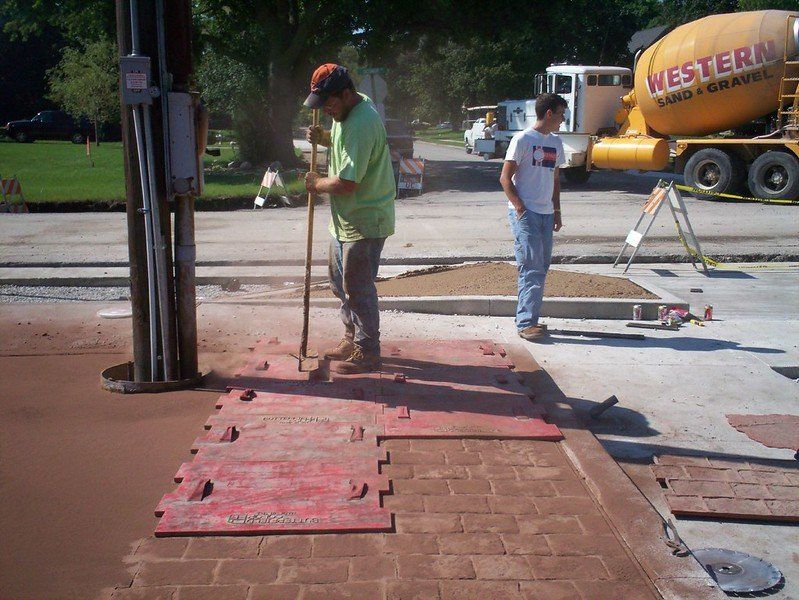 A stamp is used to make concrete pavers