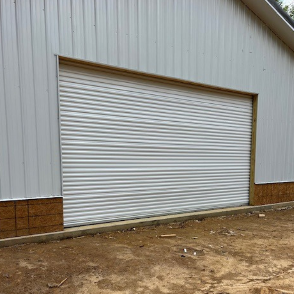 A white garage door is sitting on the side of a building