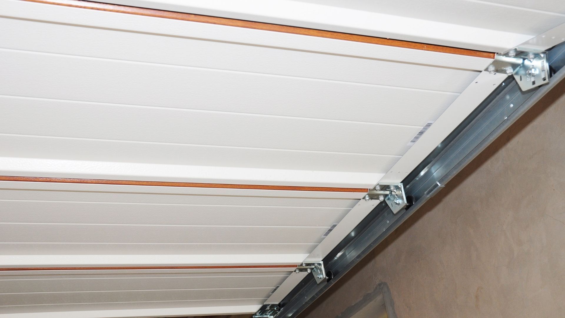 A close up of the inside of a garage door with rollers