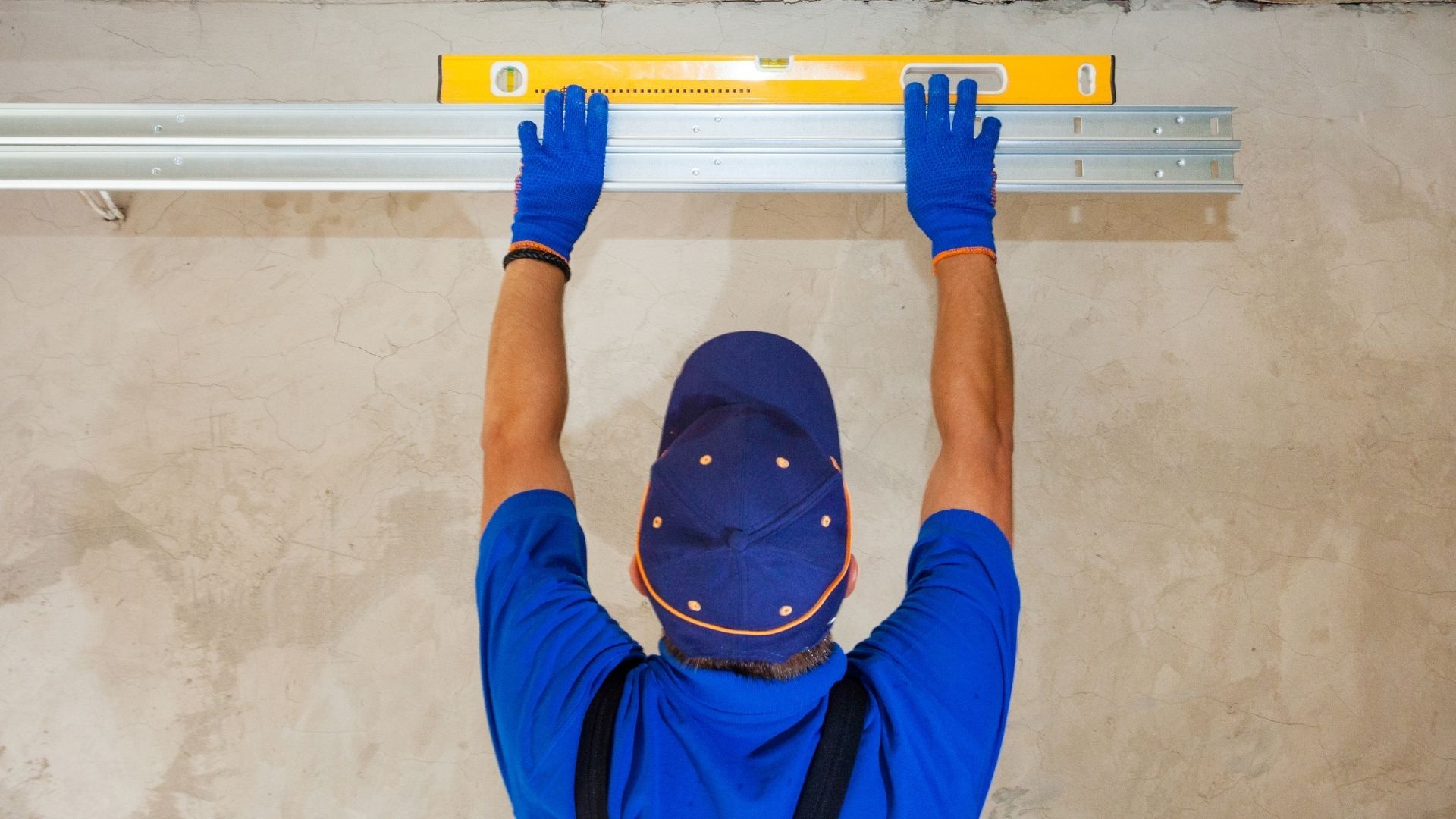 man measure garage door installation