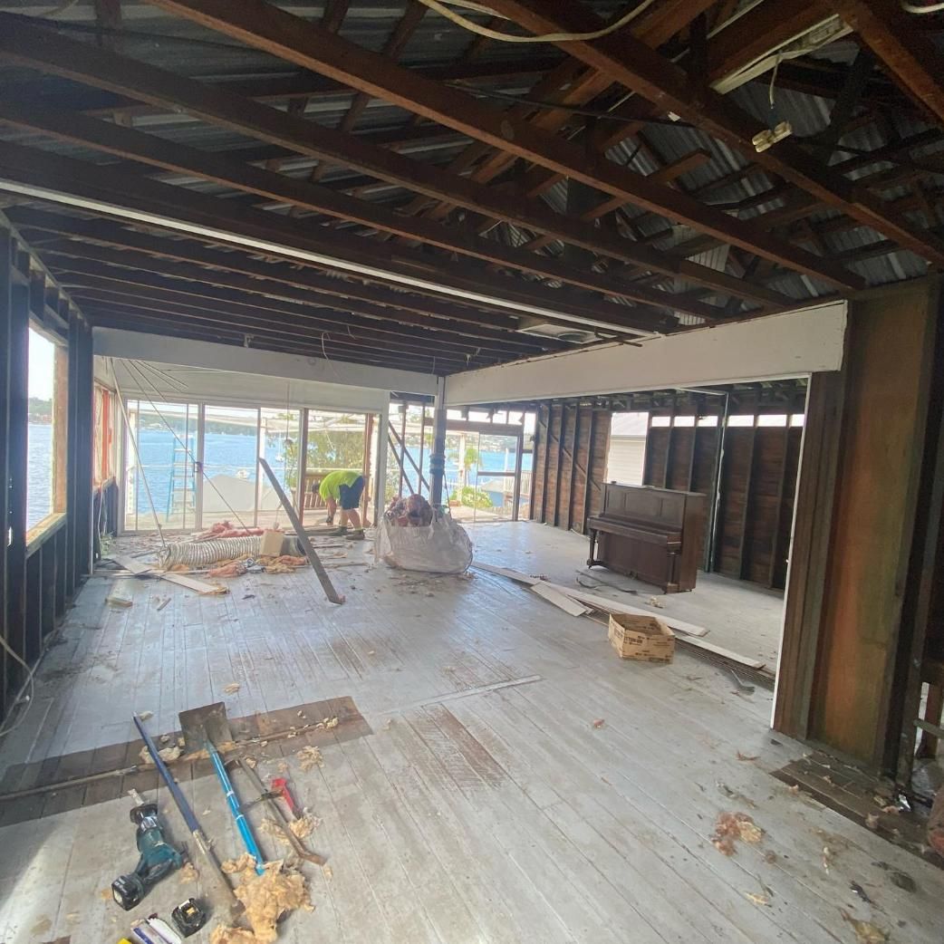 A Large Room with A Lot of Windows and Wooden Beams Is Being Remodeled — Jonobilt in Valentine, NSW