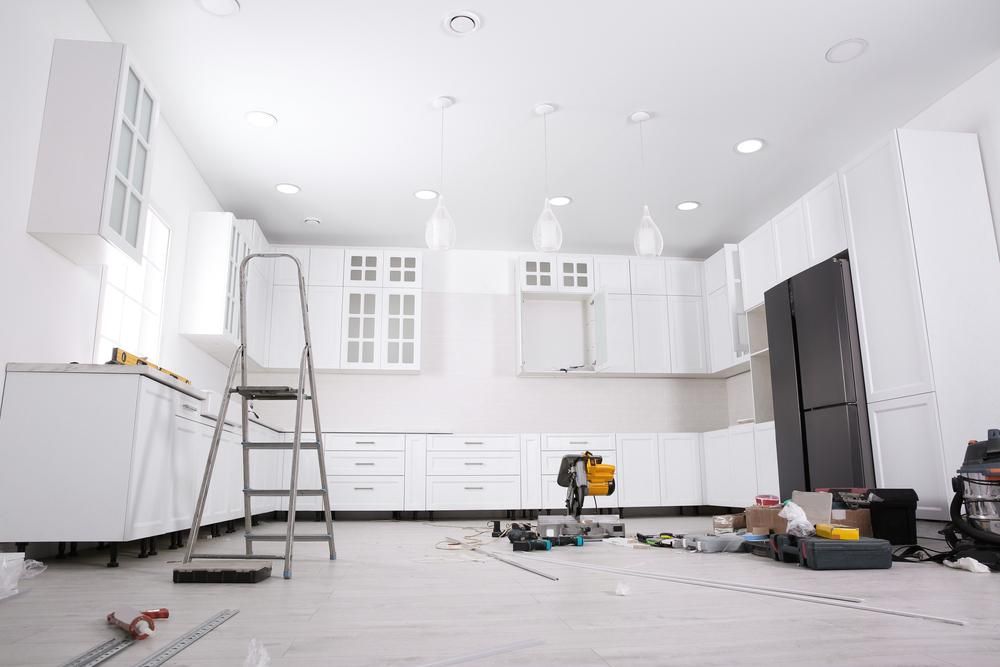 A Kitchen Is Being Remodeled with White Cabinets and A Ladder — Jonobilt in Maitland, NSW