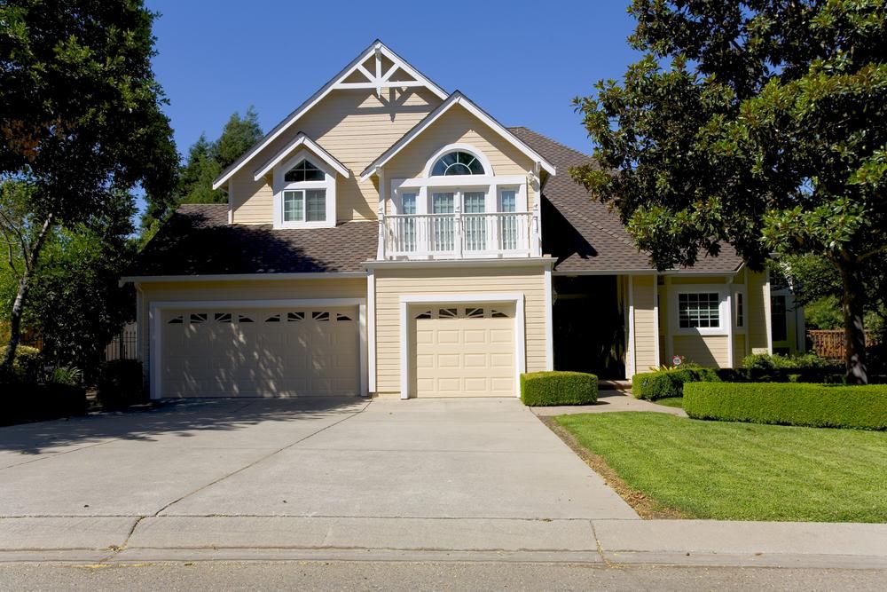 A Large House with Two Garage Doors and A Driveway — Jonobilt in Kotara, NSW