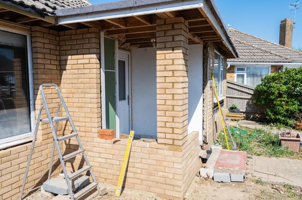 A Brick House Is Being Remodeled with A Porch and A Ladder — Jonobilt in Lake Macquarie, NSW