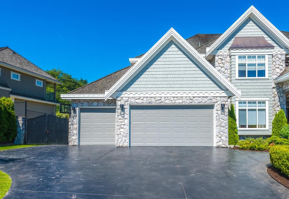 A Large House with Two Garage Doors and A Long Driveway — Jonobilt in Cameron Park, NSW