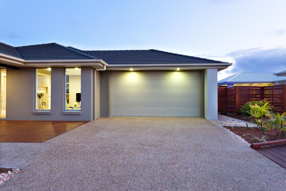 A House with A Garage Door and A Driveway in Front of It — Jonobilt in New Lambton, NSW