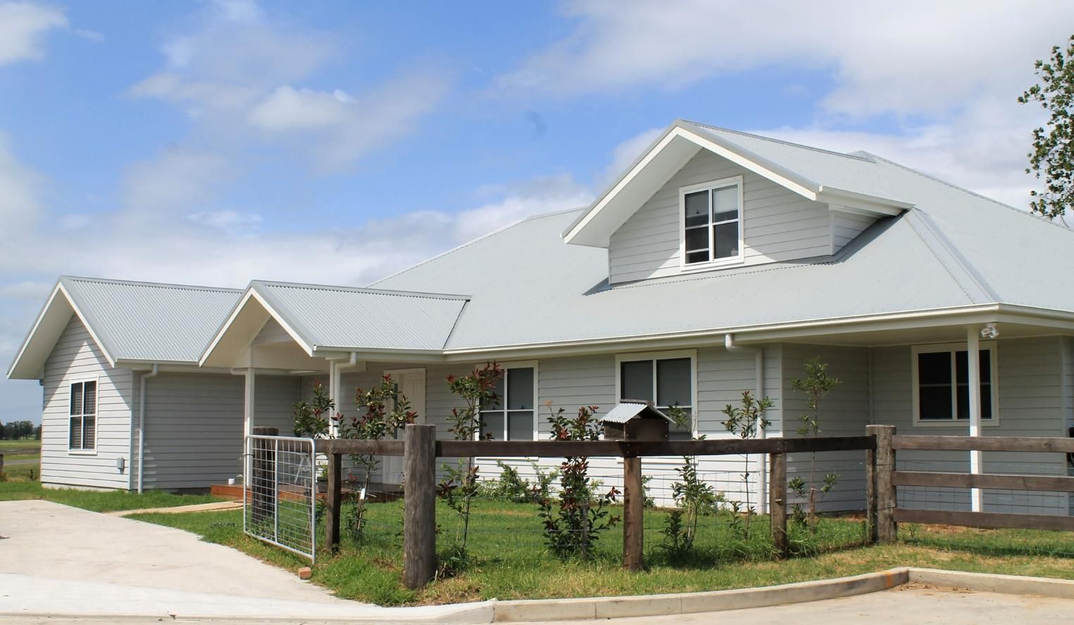 A White House with A Fence in Front of It — Jonobilt in Wallsend, NSW