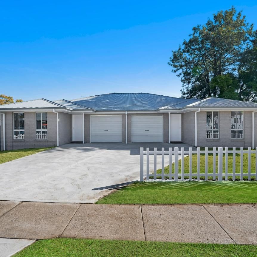A House with A White Picket Fence in Front of It — Jonobilt in Merewether, NSW