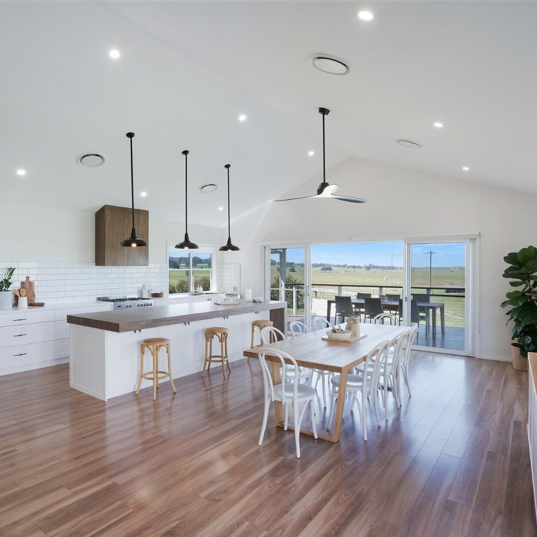 A Kitchen with A Large Island and Three Wooden Stools — Jonobilt in Bolwarra, NSW