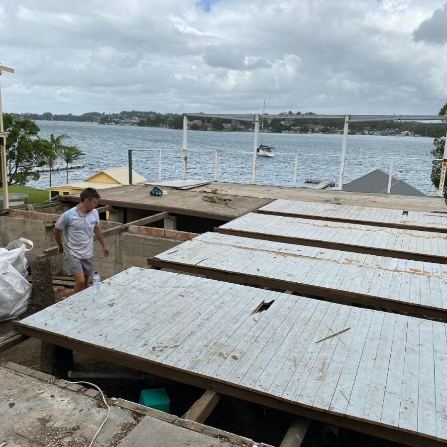 A Man Is Standing on A Deck Overlooking a Body of Water — Jonobilt in Wallsend, NSW